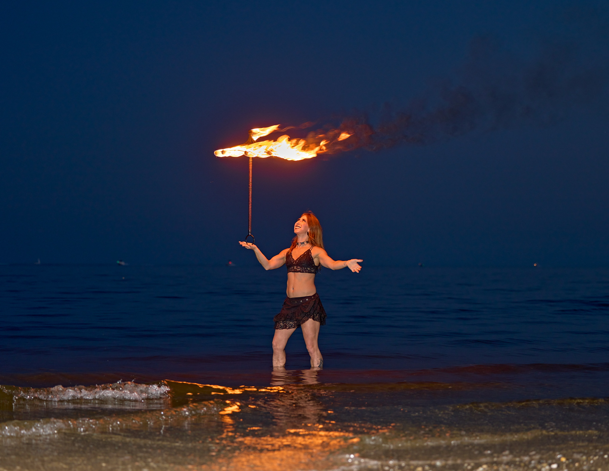 Lady Blaze balancing a fire parisol on her hand.